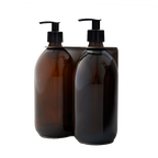 Two brown glass bottles with black pump dispensers on a white background