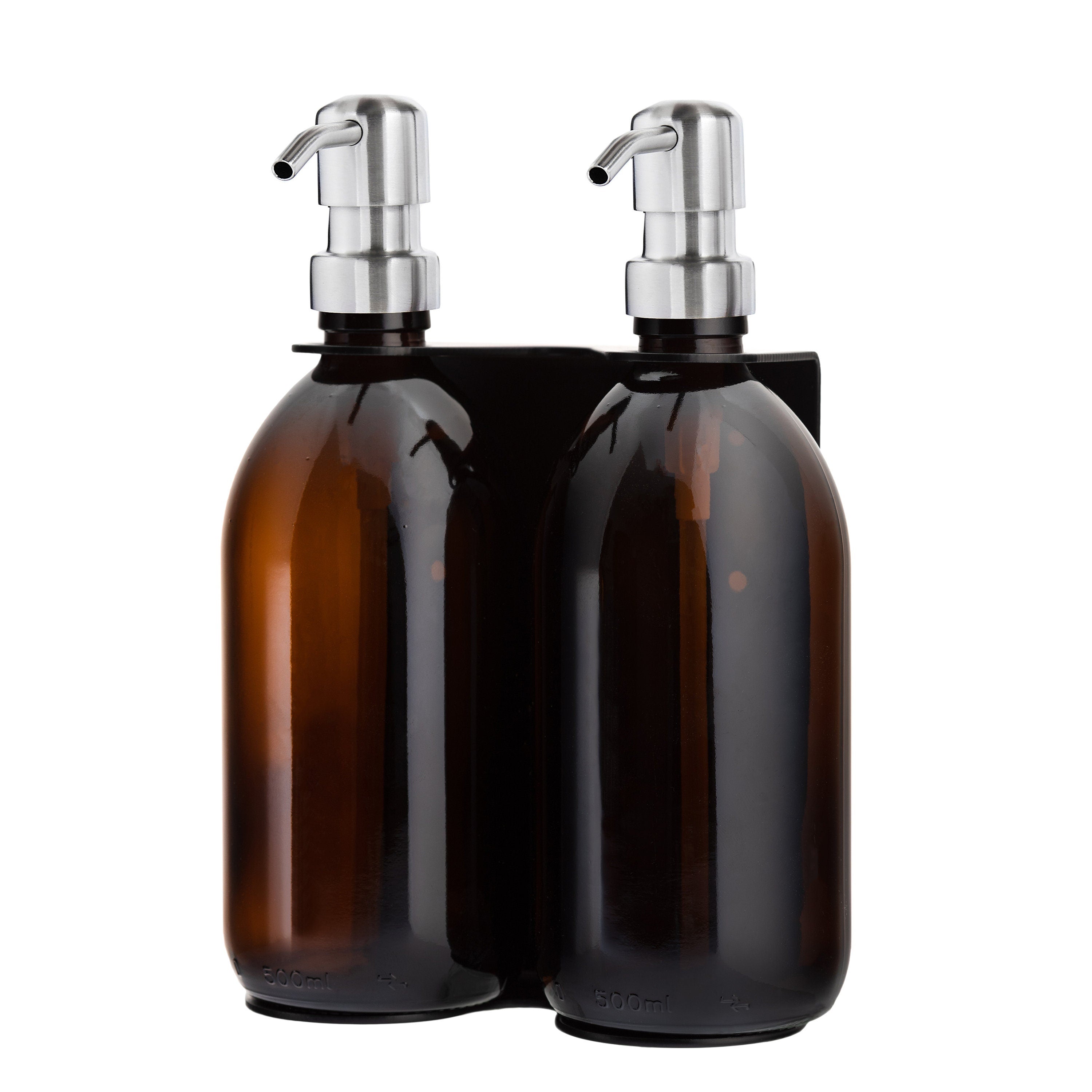 Two amber glass bottles with silver pumps in a black holder on a white background