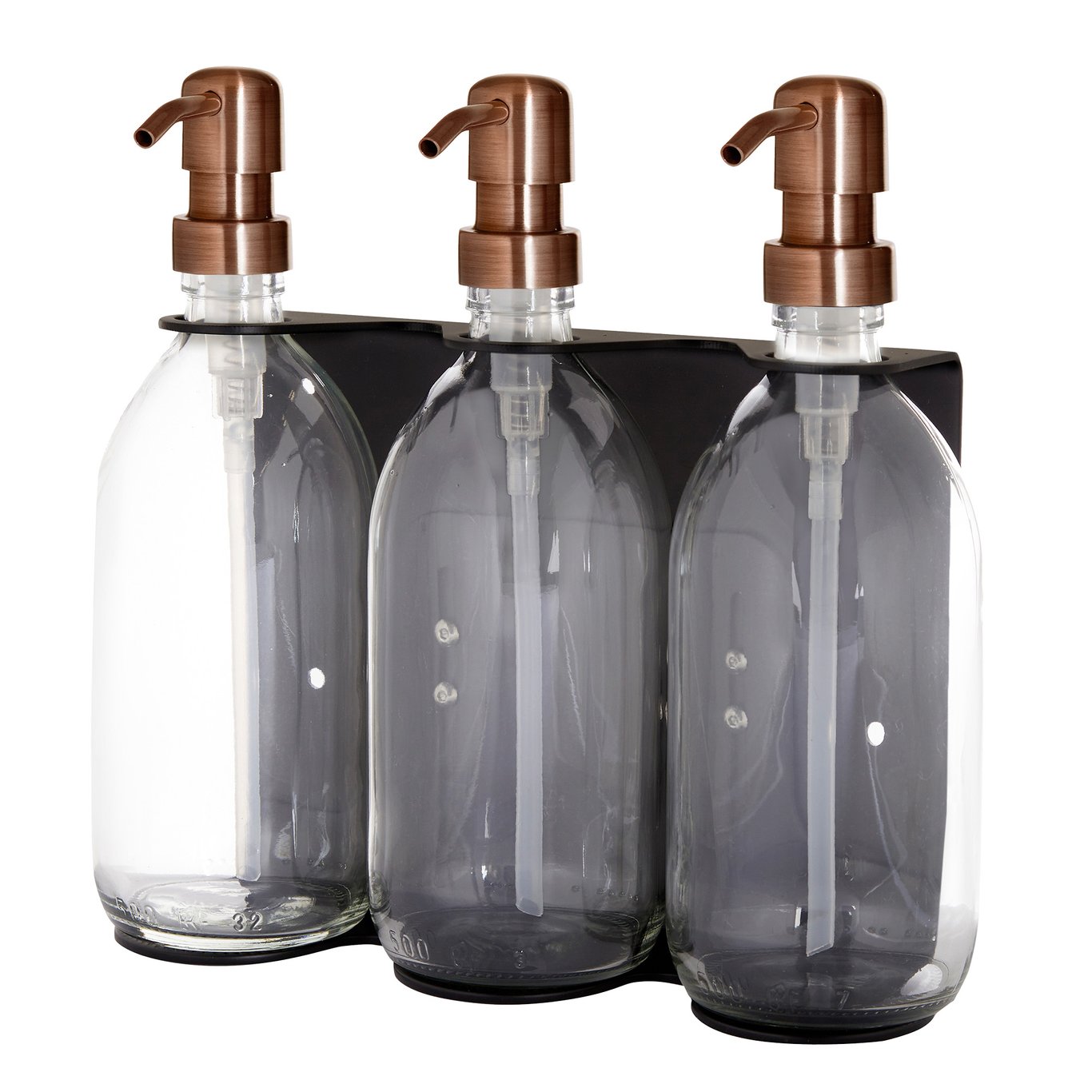 Three glass bottles with bronze pumps in a black holder on a white background
