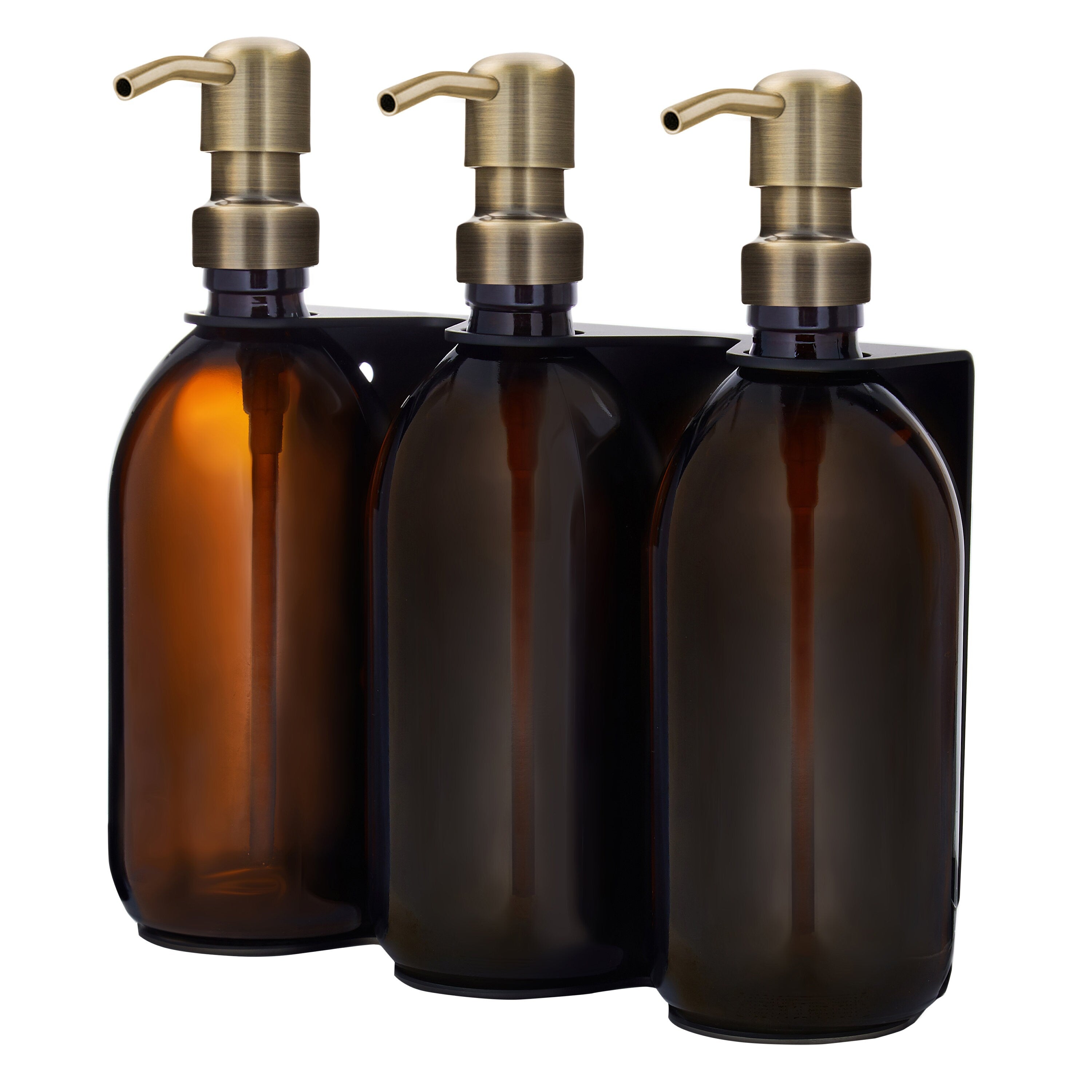 Three amber glass bottles with bronze pumps on a white background