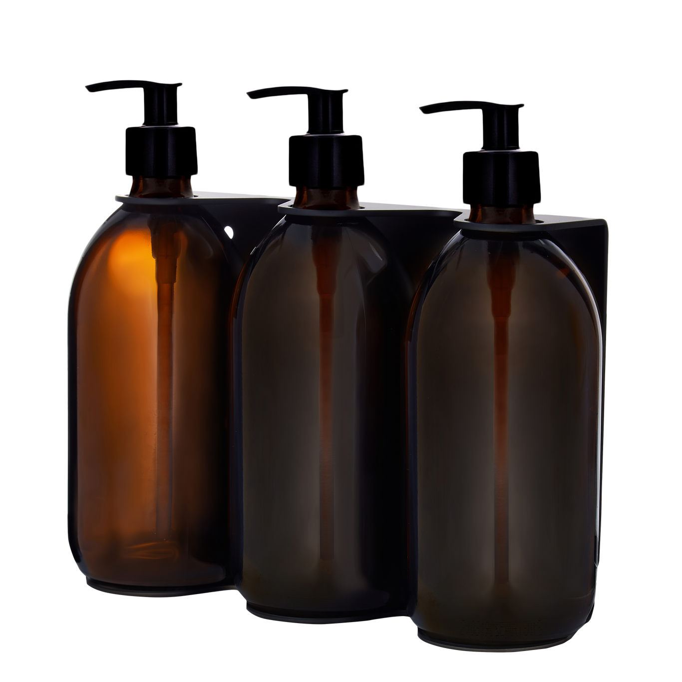 Three amber glass bottles with black pump dispensers on a white background