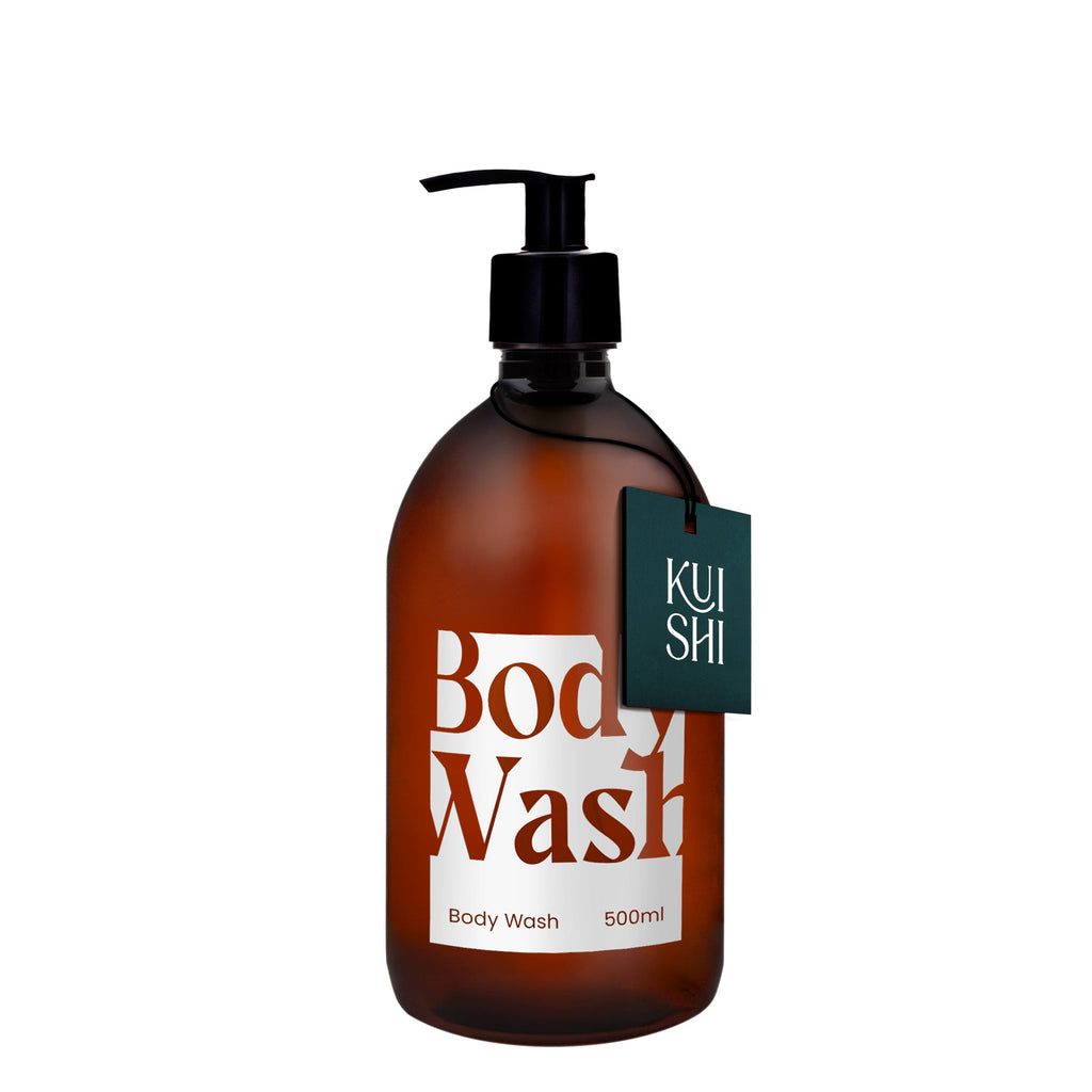 Brown bottle of body wash with a pump and 'Kushi' label on a white background