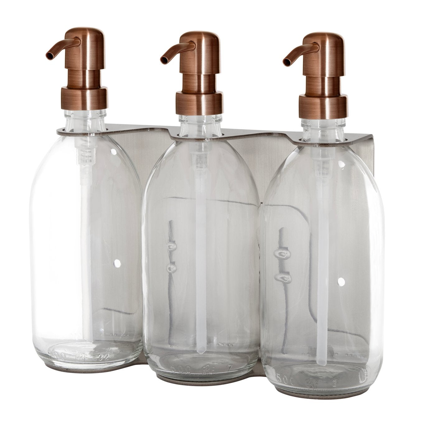 Three clear glass bottles with copper pumps on a white background