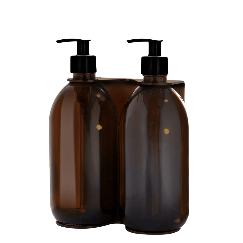 Two brown plastic bottles with black pump dispensers on a transparent background