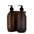 Two brown plastic bottles with black pump dispensers on a transparent background