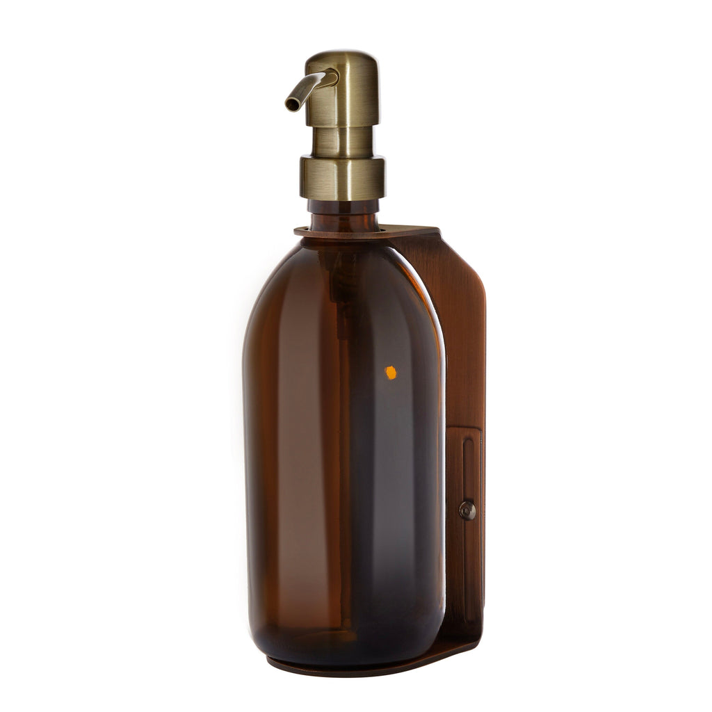 Brown glass bottle with a gold pump on a white background