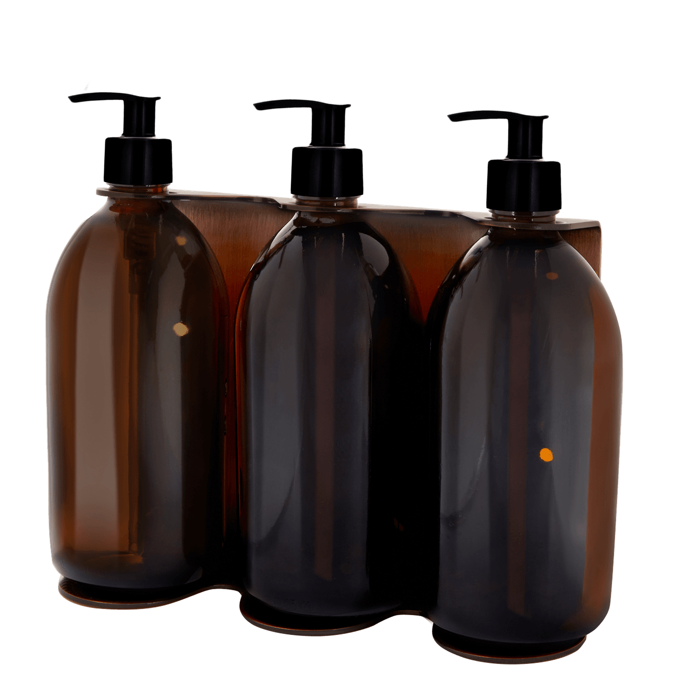 Four amber glass bottles with black pumps in a clear packaging holder on a white background