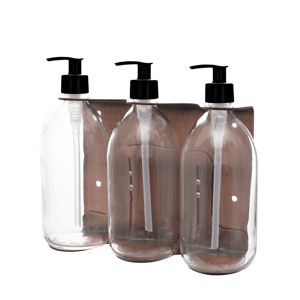 Three clear plastic bottles with black pump dispensers on a transparent background