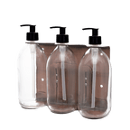 Three clear plastic bottles with black pump dispensers on a transparent background