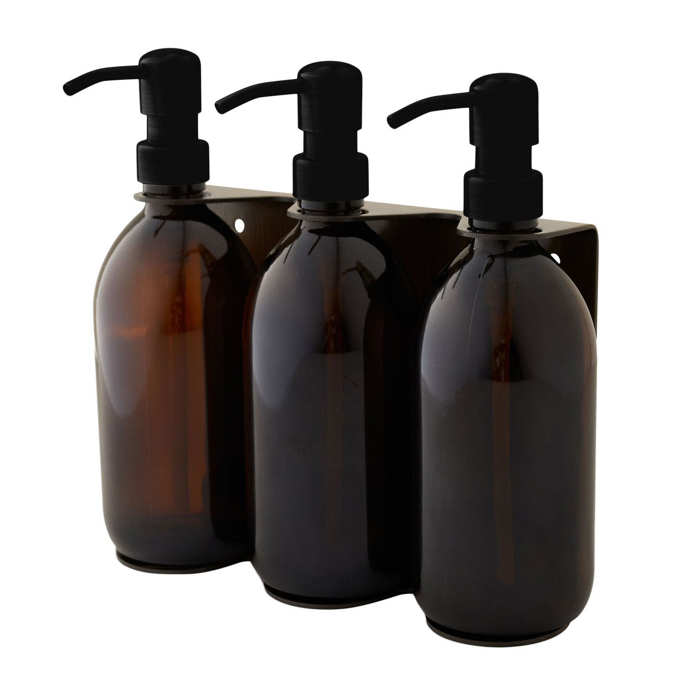 Three amber glass bottles with black pumps on a white background