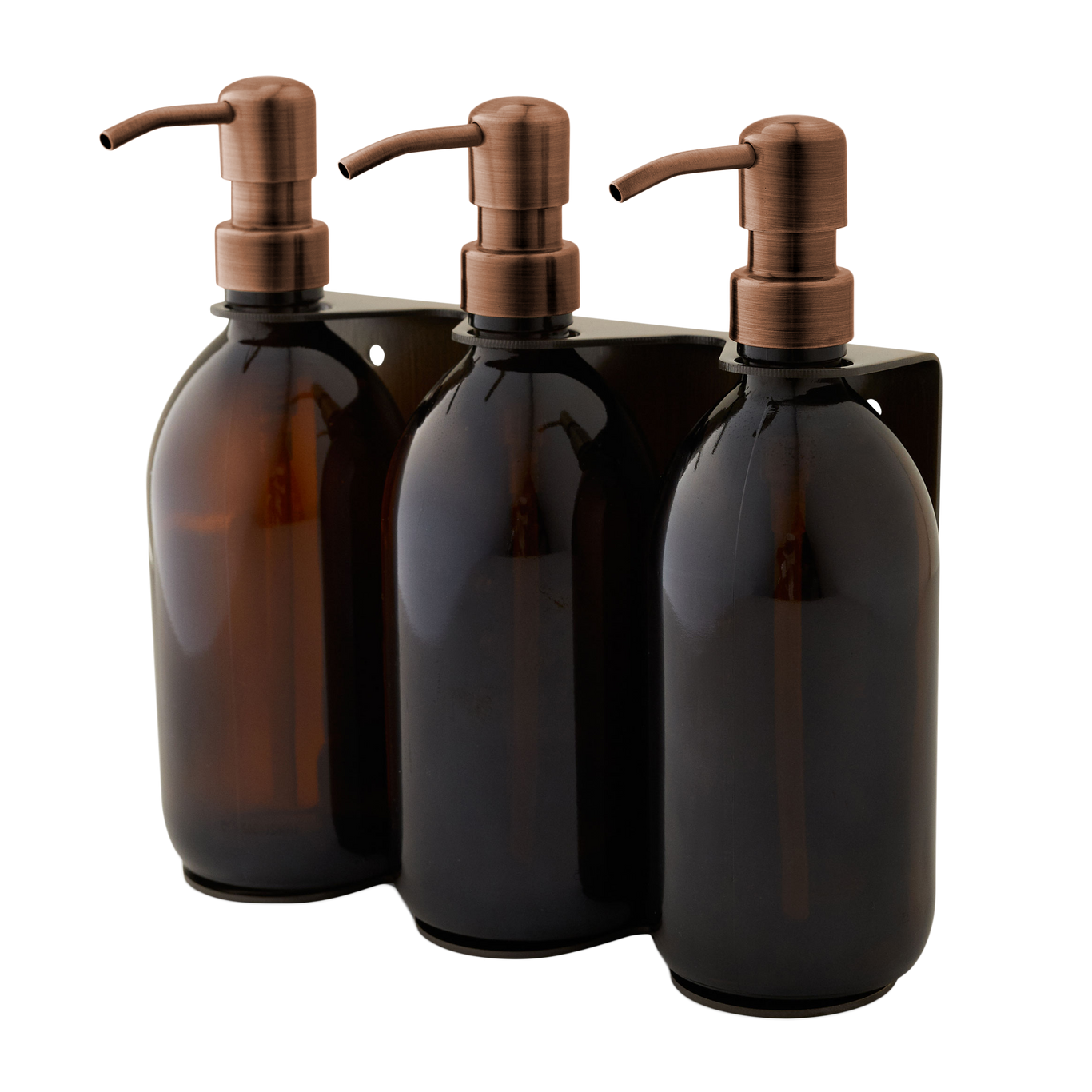 Three brown glass bottles with bronze pumps in a black holder on a white background
