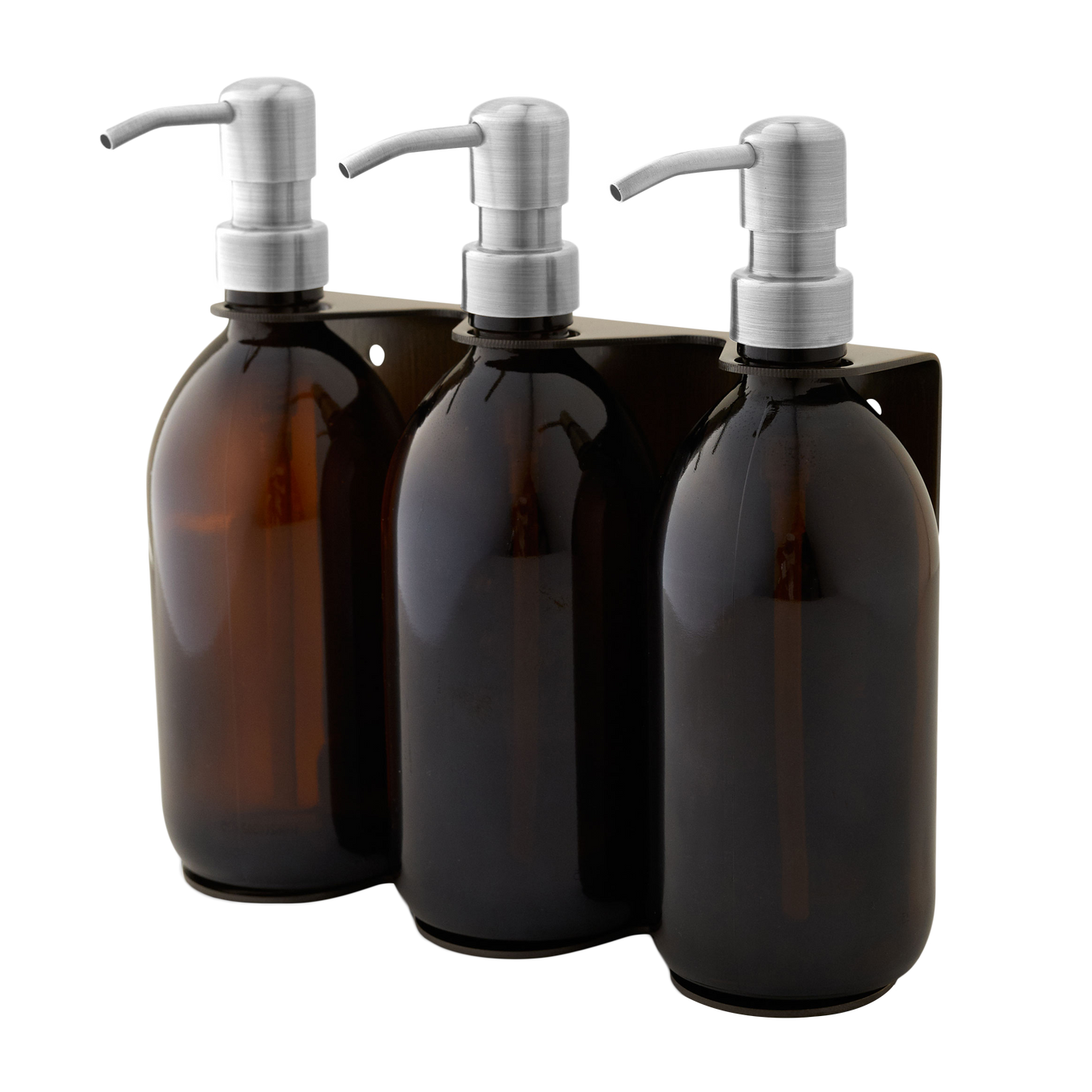 Three amber glass bottles with silver pumps in a black holder on a white background