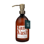 Brown bottle of hand wash with pump and 'Kushi' label on a white background