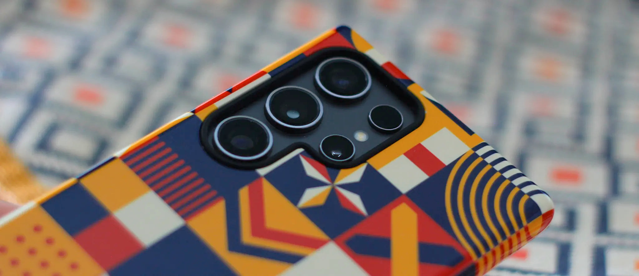 Samsung Galaxy S24 Ultra phone and case with colorful geometric-patterned phone case on a patterned background bought from MVB STUDIO official store.