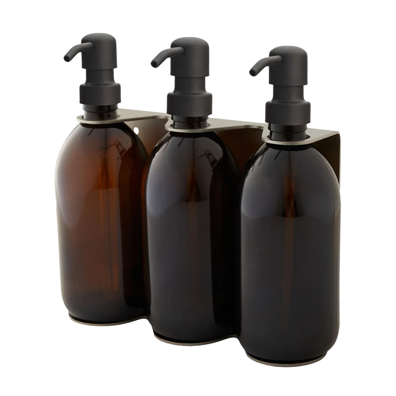Three amber glass bottles with black pumps in a holder on a white background
