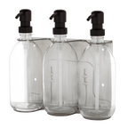 Three clear plastic bottles with black pump dispensers in a transparent packaging.