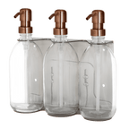 Three clear glass bottles with copper pumps on a transparent background