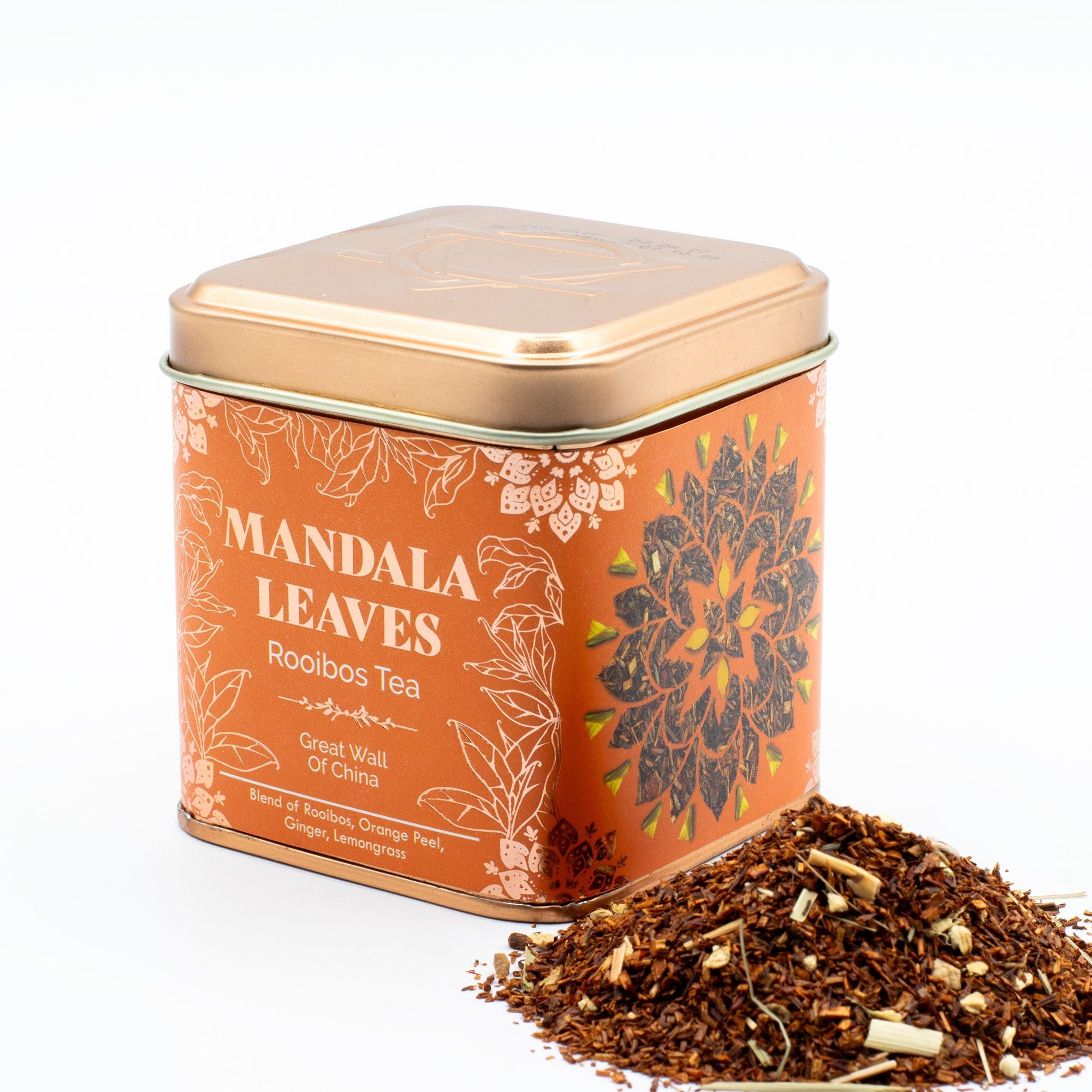 Tea tin labeled 'Mandala Leaves Rooibos Tea' with tea leaves spilling out on a white background