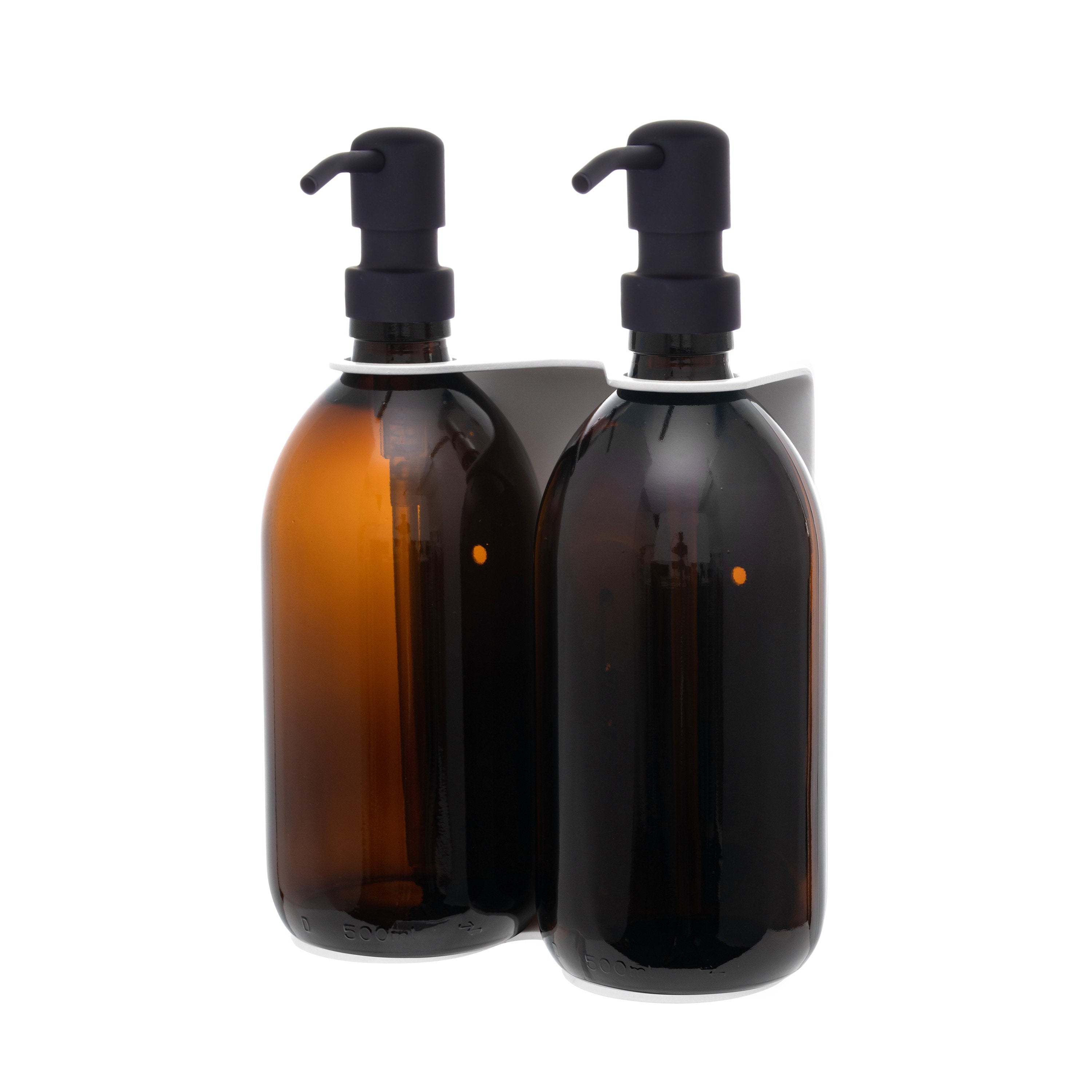 Two amber glass bottles with black pumps on a white background