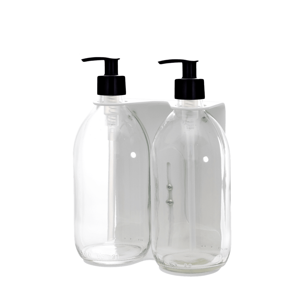Two clear plastic bottles with black pump dispensers on a dark blue background