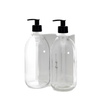 Two clear plastic bottles with black pump dispensers on a dark blue background