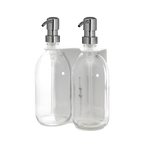 Clear glass bottles with silver pumps on a dark blue background