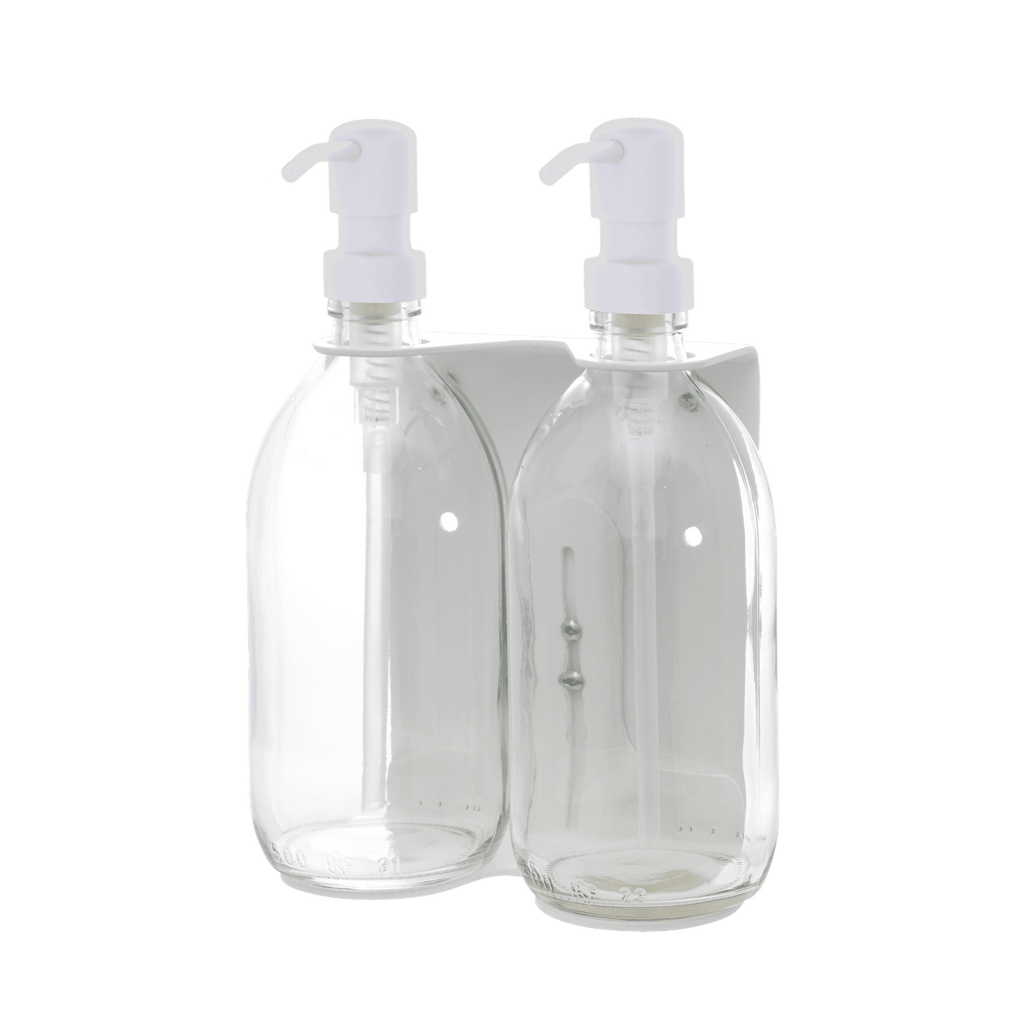 Two clear bottles with white pump dispensers on a dark blue background