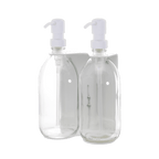 Two clear bottles with white pump dispensers on a dark blue background