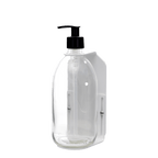 Clear plastic bottle with black pump on a dark gray background